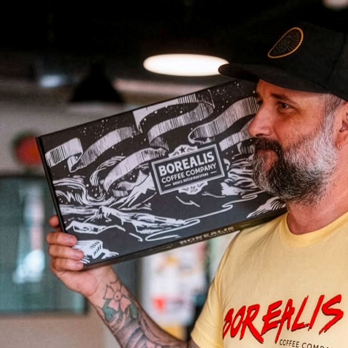 Founder holding a Borealis coffee box
