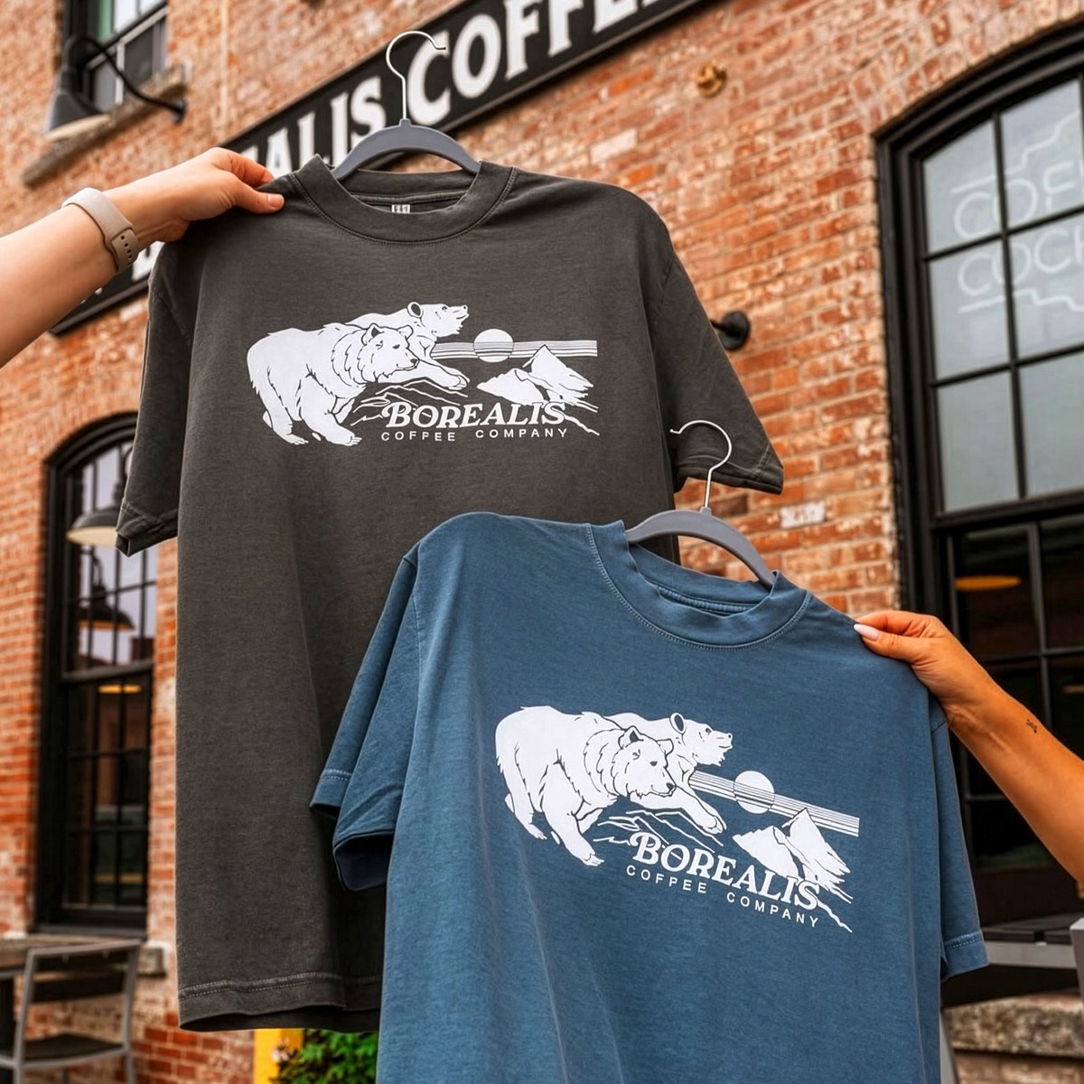 Two t-shirts with bear illustration, worn outside the roastery