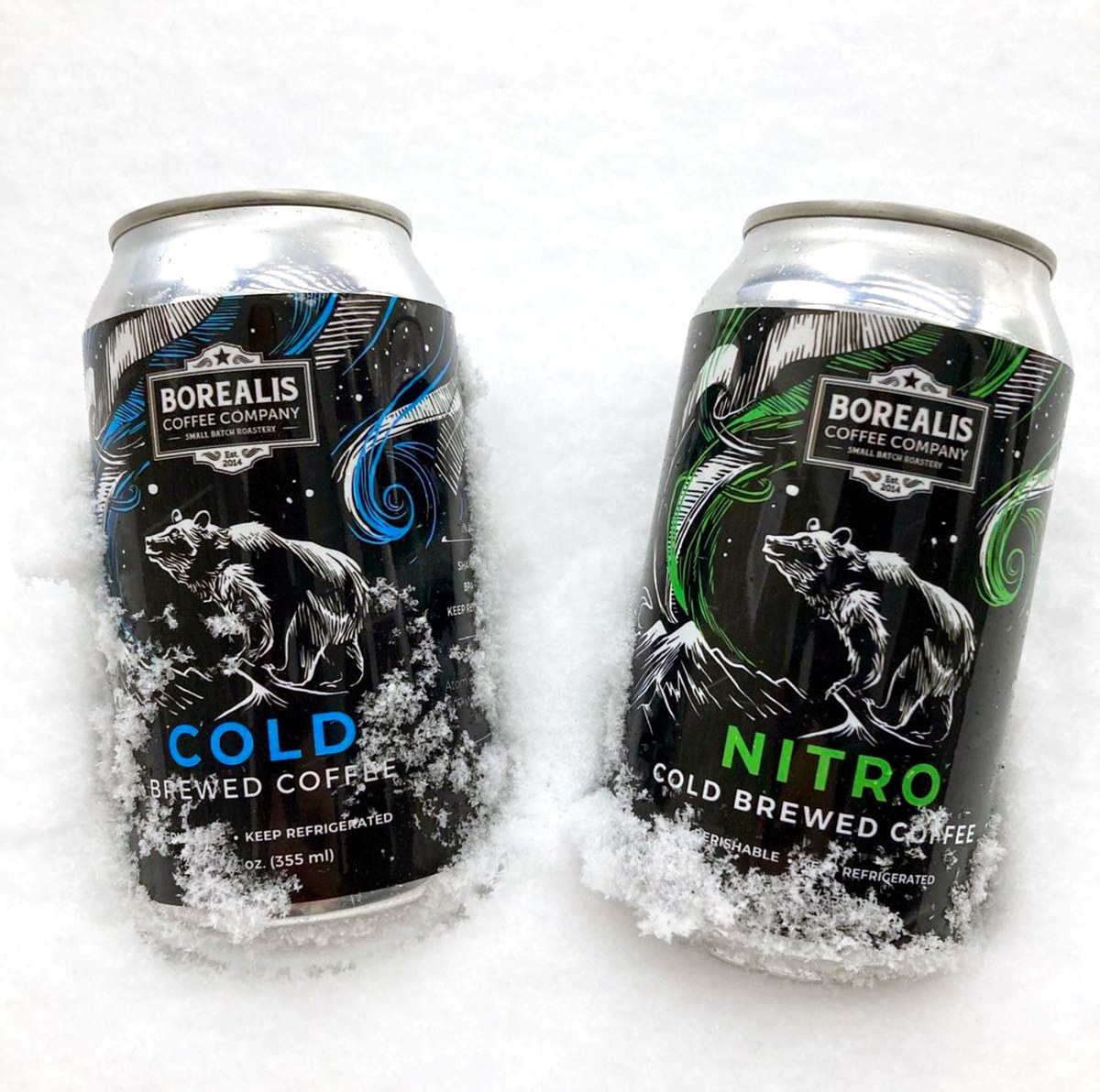 Cold brew cans in the snow, blue and green