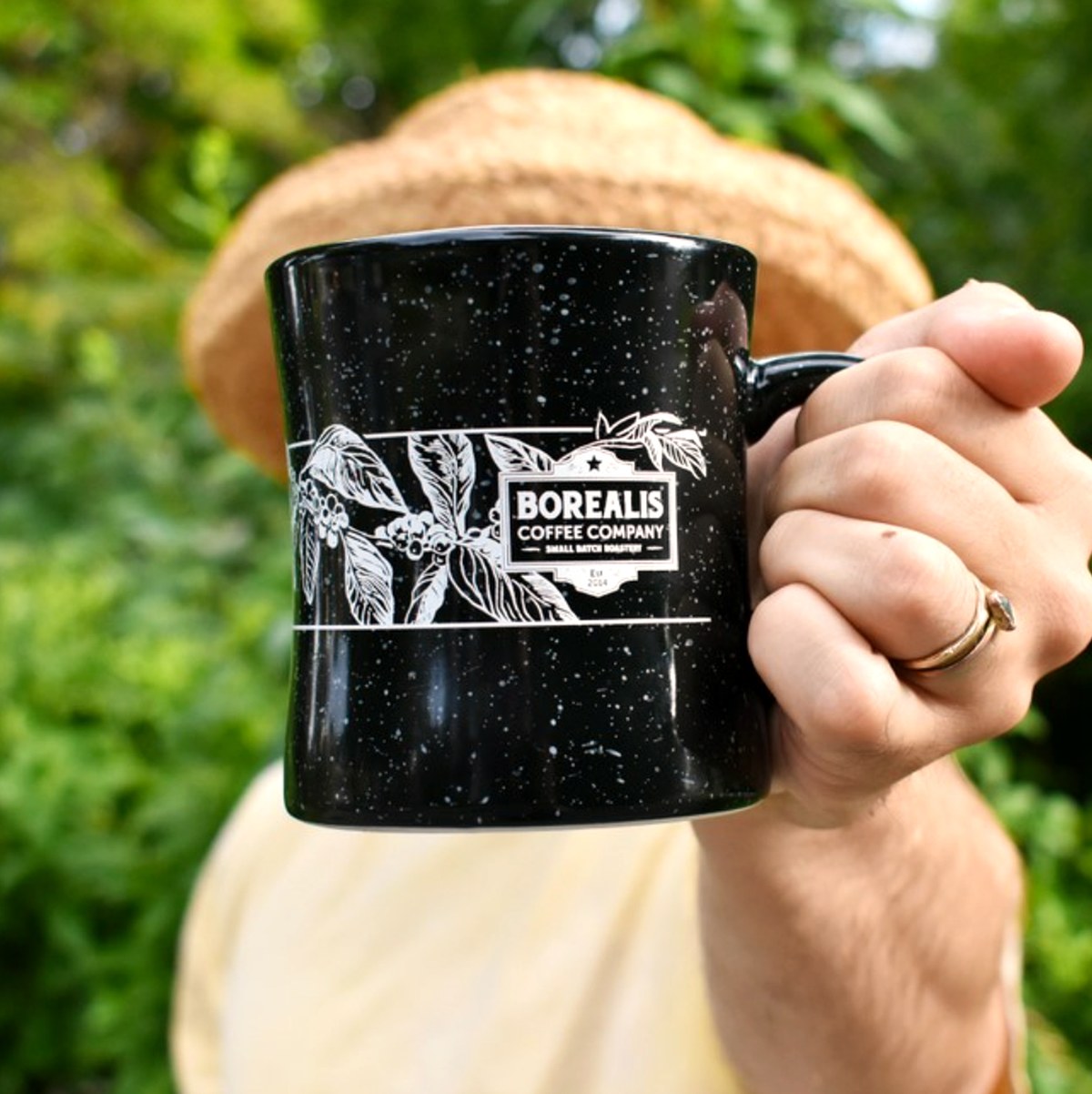 Engraved mug held outdoors