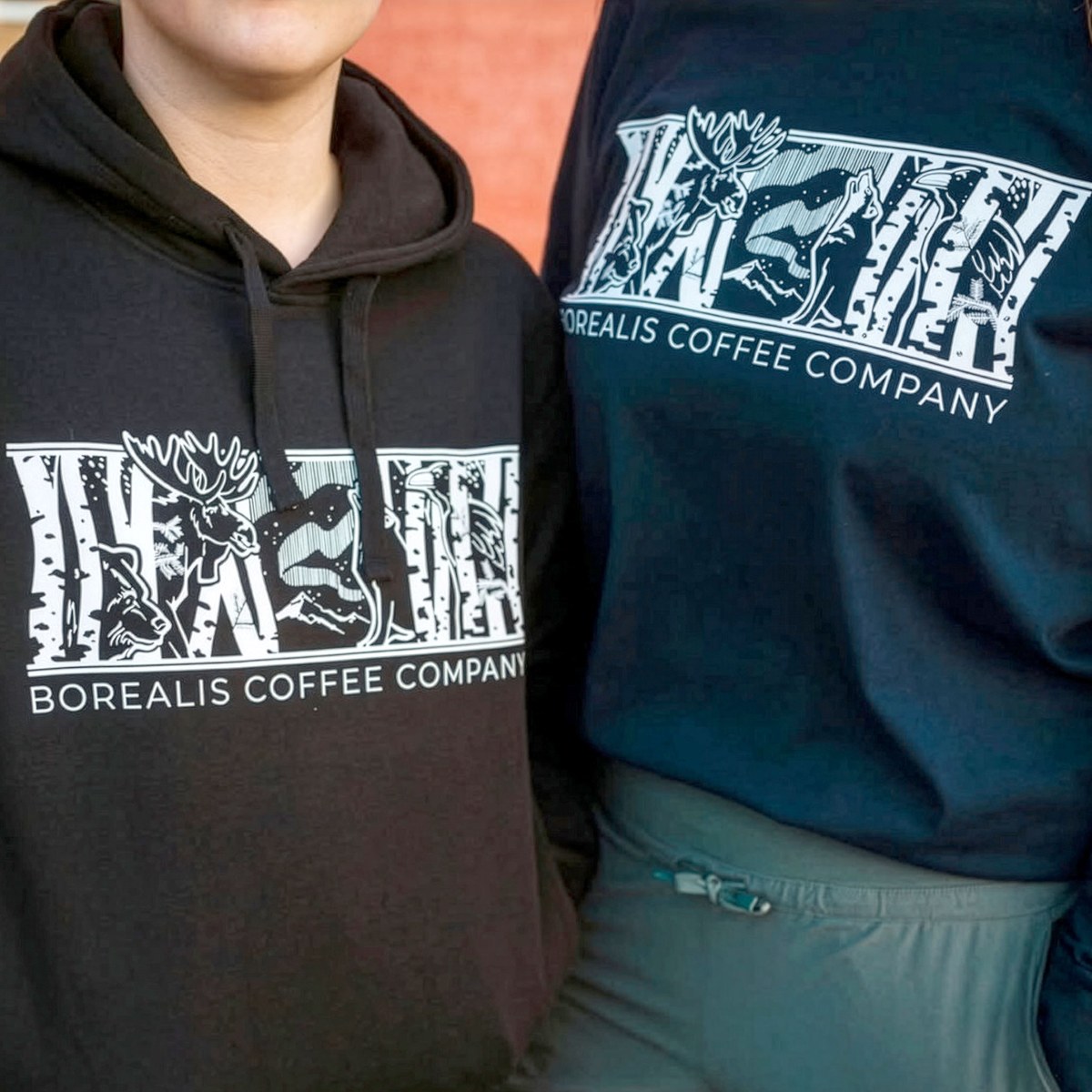 Two hoodies with a full illustrated animal scene
