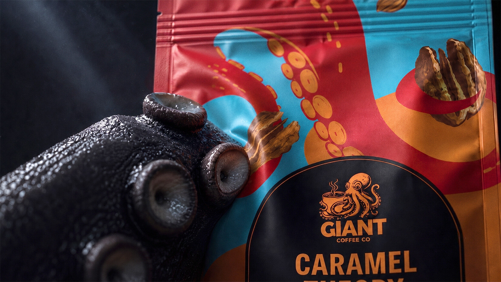 Macro of a wet three-dimensional tentacle meeting the flat graphic tentacle printed on the Caramel Theory bag