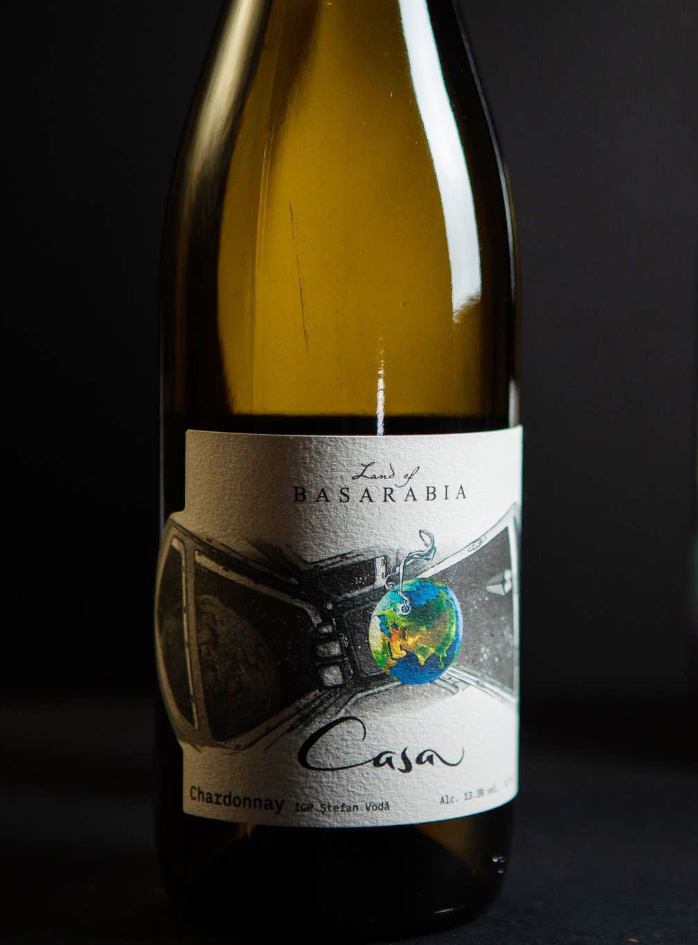Casa — a cockpit window, Earth hanging from it like a Christmas ornament