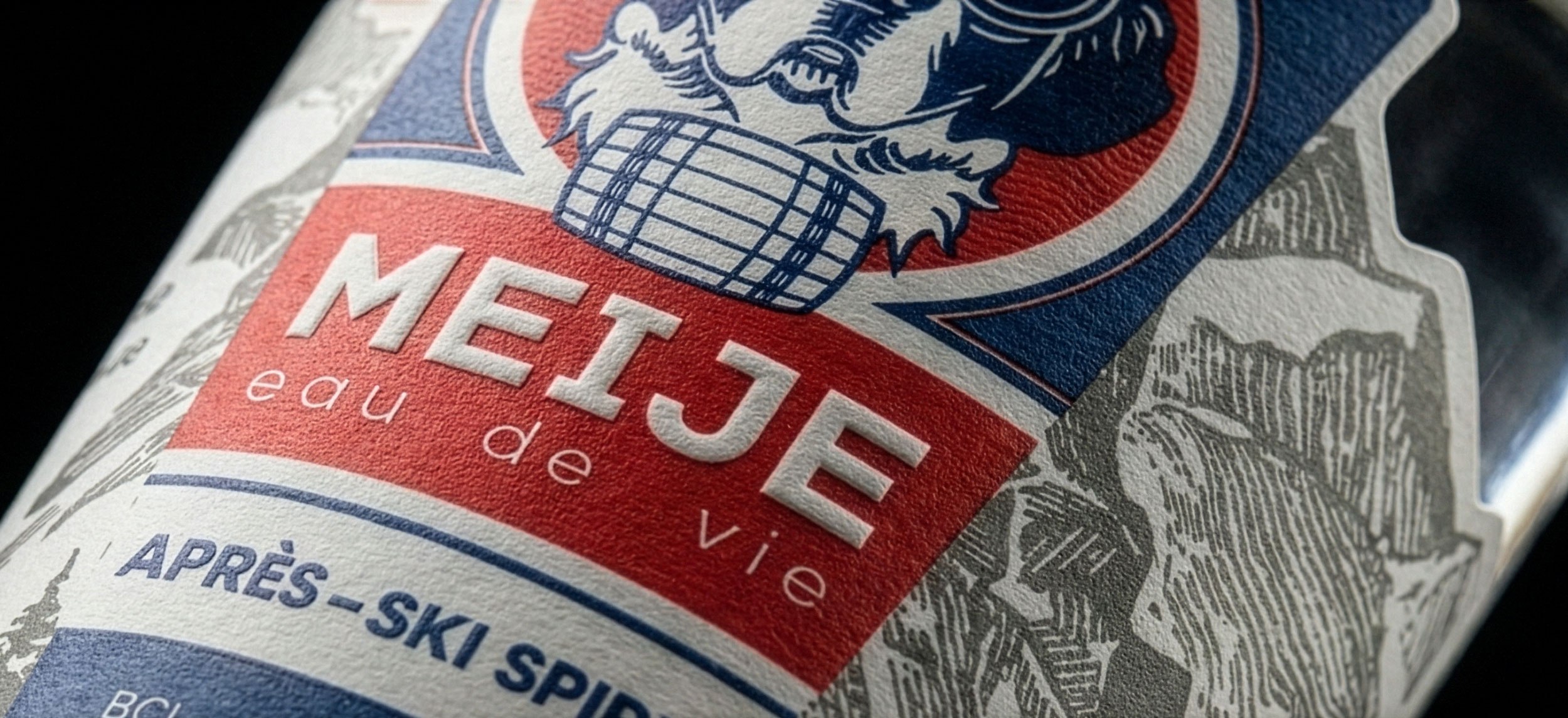 A macro shot of the embossed Meije wordmark and barrel icon