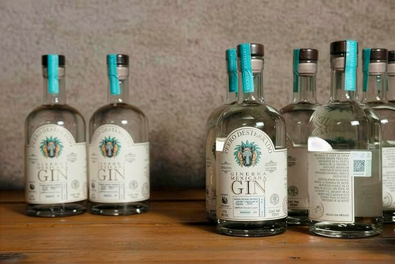 Bottles lined up on a wooden shelf, fresh off the line