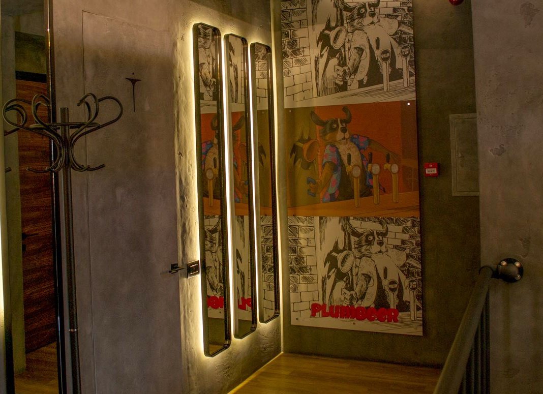 A Plumbeer comic strip printed across a wall
