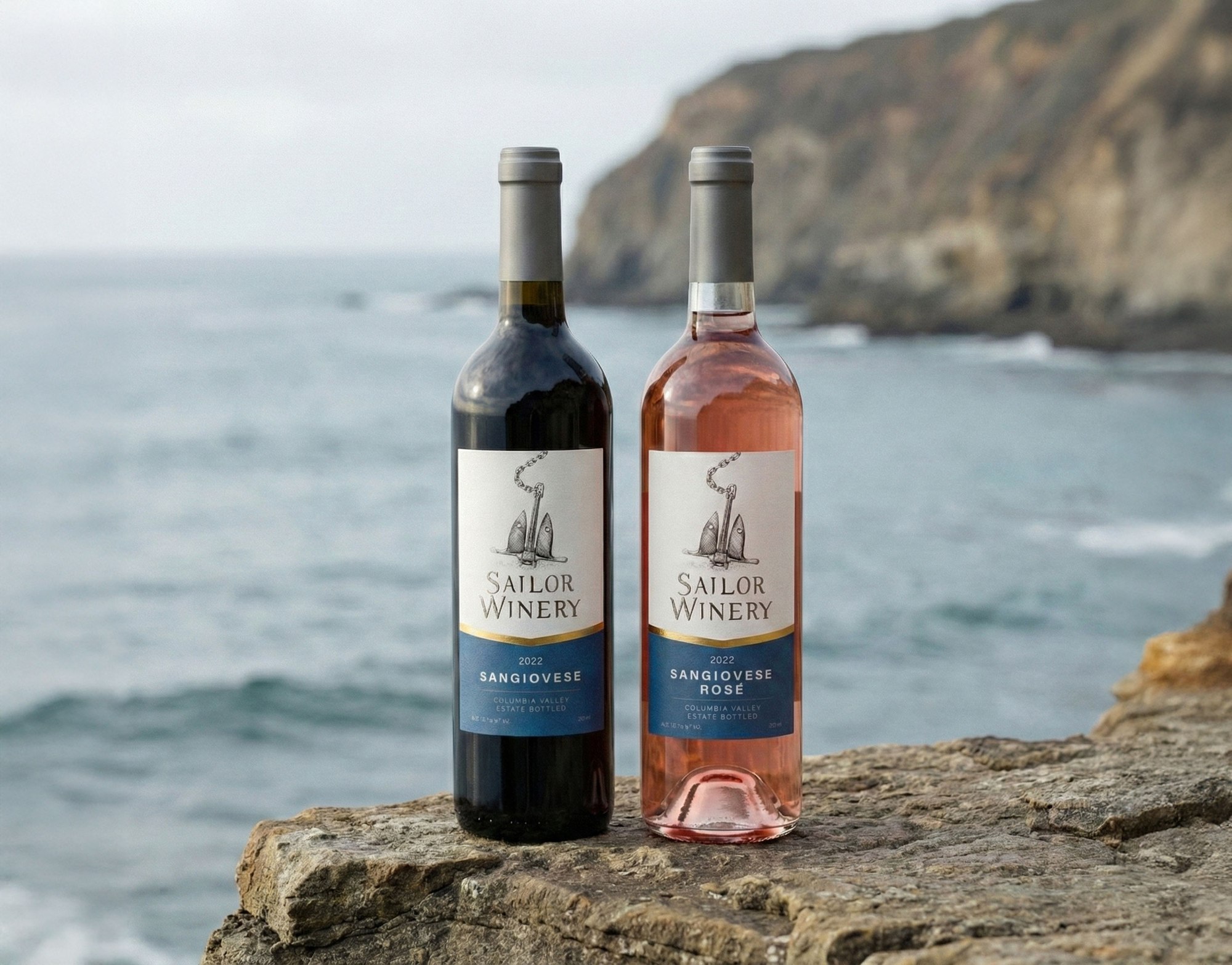 The Sangiovese and the Ros&eacute; standing together on a rock, open water and headland behind them