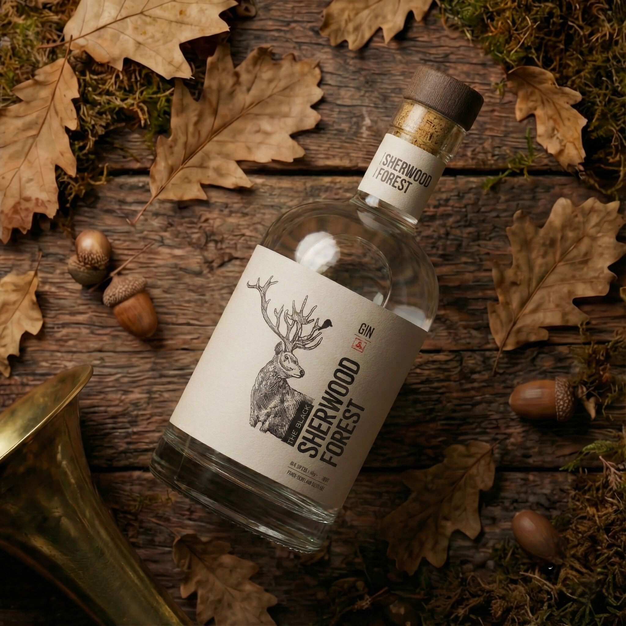 The bottle lying among oak leaves and acorns beside a brass horn