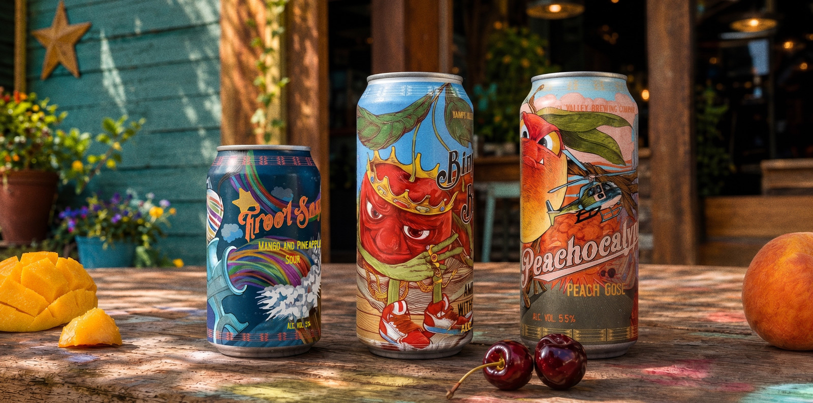 Three one-off cans on a summer terrace — Froot Snax mango and pineapple sour, Bing Bing Blink american sour, and Peachocalypse peach gose