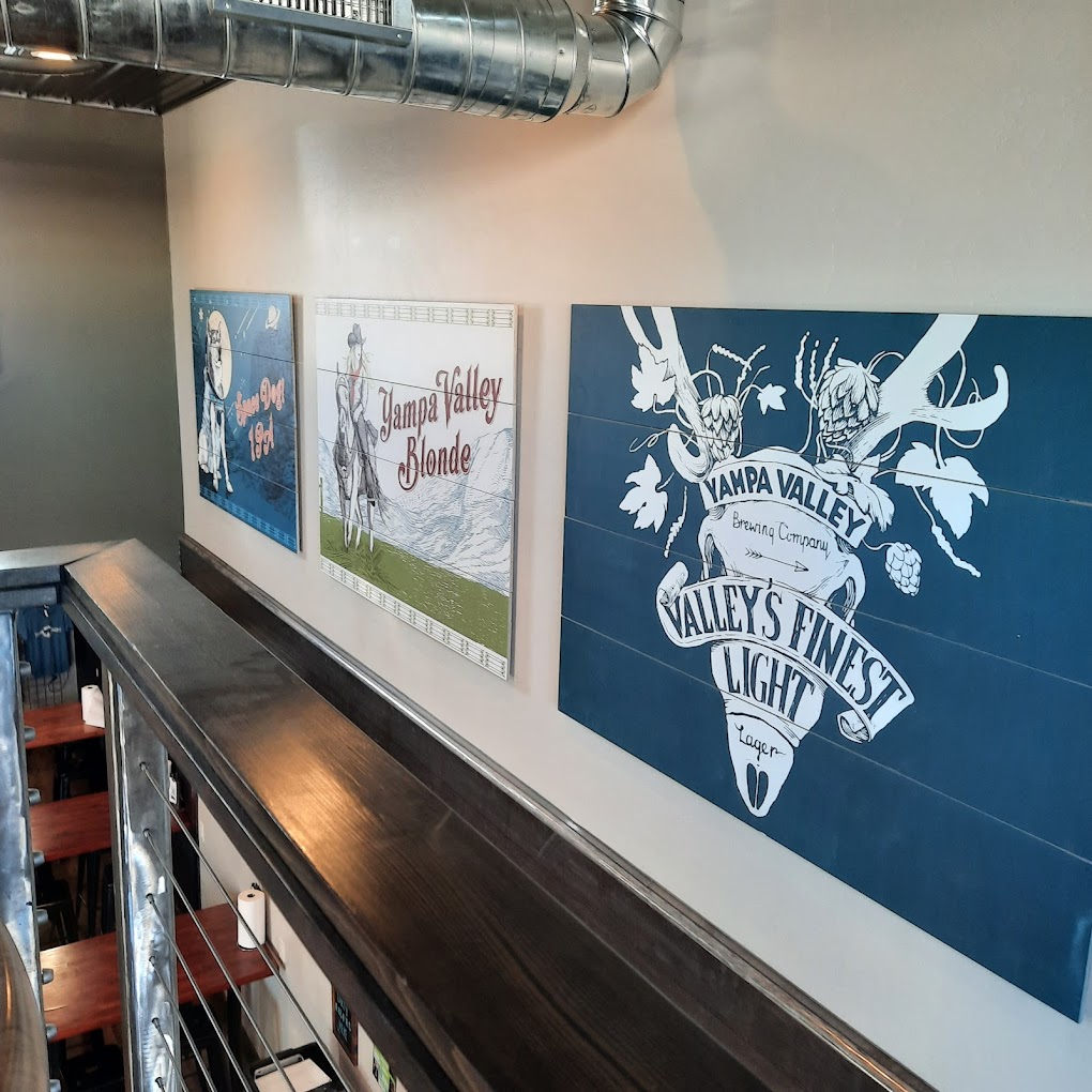 The Yampa Valley delivery van wrapped in the illustrations — Space Dog down the side, Valley Girl across the back doors