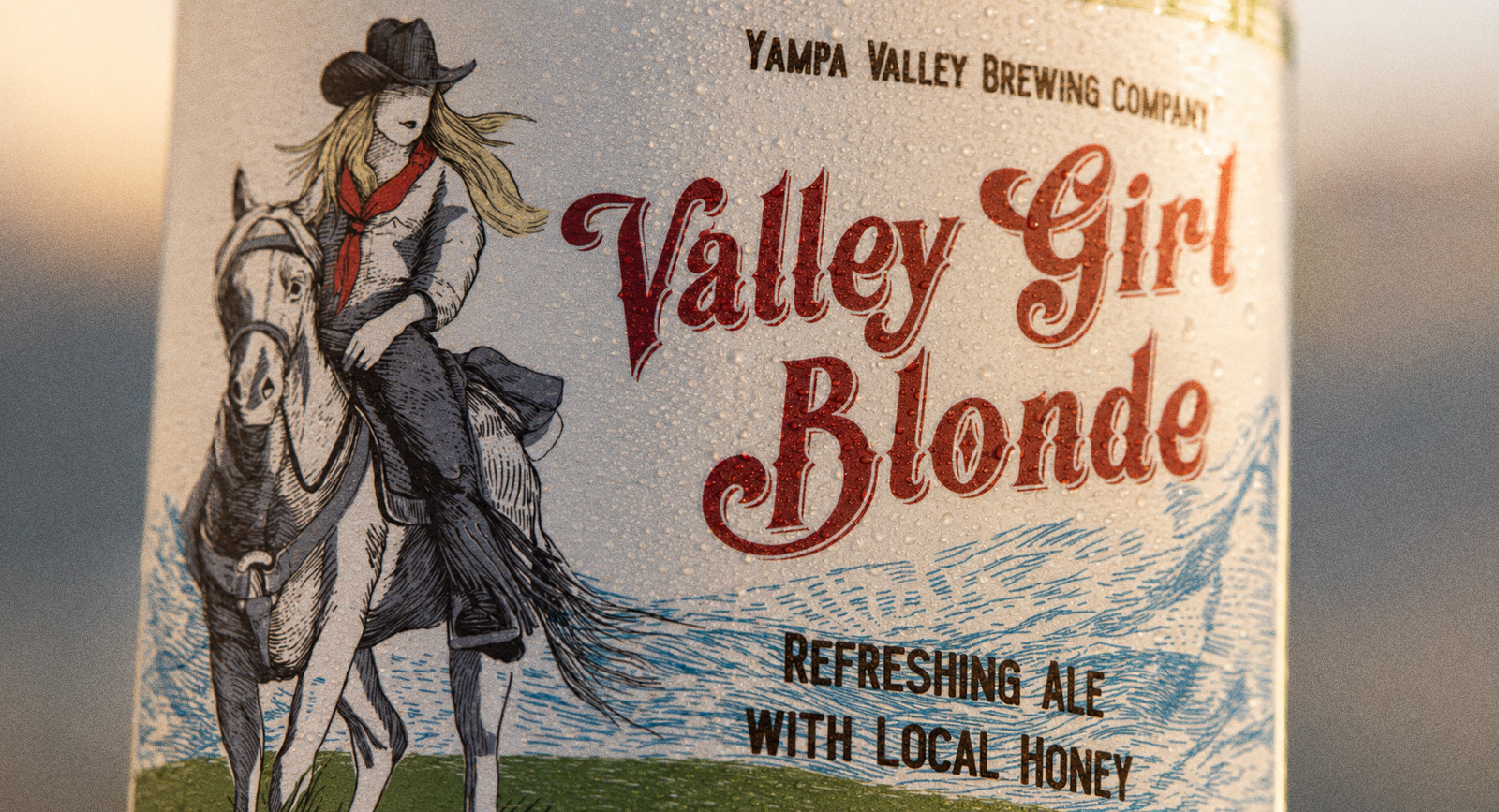 Macro of the Valley Girl Blonde label — the engraved rider on horseback, hand-drawn line up close