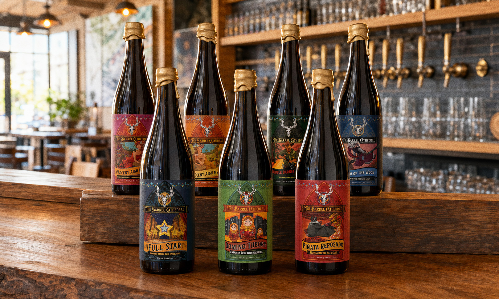 The Barrel Cathedral series lined up on a bar — seven gold-waxed bottles, each with a gothic arched label under the stag-skull mark