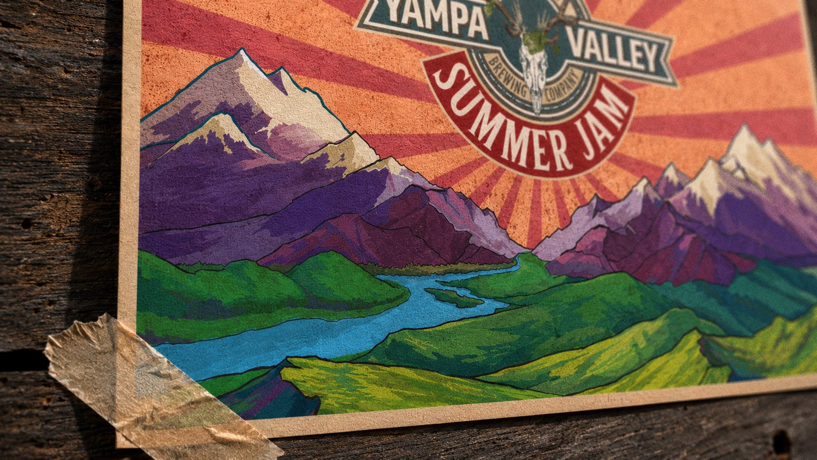 Hands taping the Summer Jam poster to a weathered barn wall — mountains, sunburst and the stag-skull mark up top